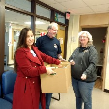Kay Emmert (President) and Dennis Dullea (Stewards Council Chair) present school supplies to staff member at MLK jr. Elementary School.